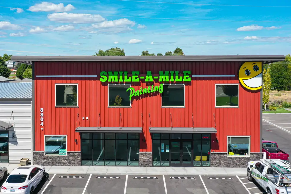 The red two-story Smile-A-Mile office at 8804 W Victoria Ave with the company sign and yellow smiley